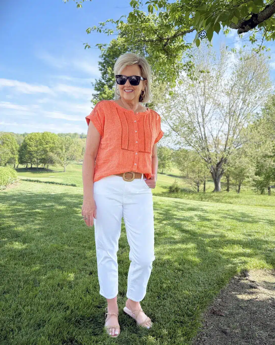 Tania Stephens wearing coral pintuck linen top with white jeans in a summer outfit